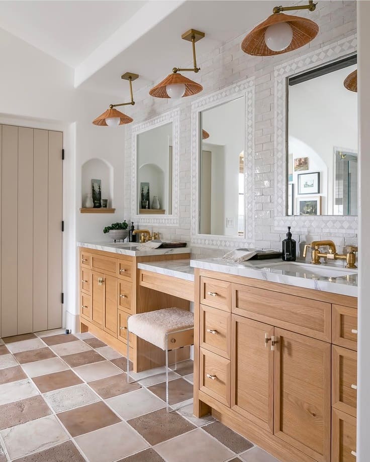 light oak vanity with marble top and tile floor