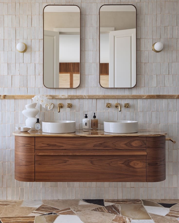 floating walnut vanity with double mirrors and soft tile
