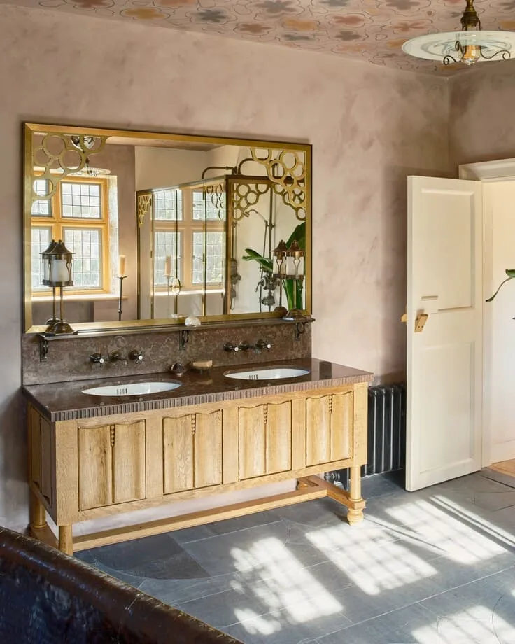 hand-carved wood vanity with large gold mirror