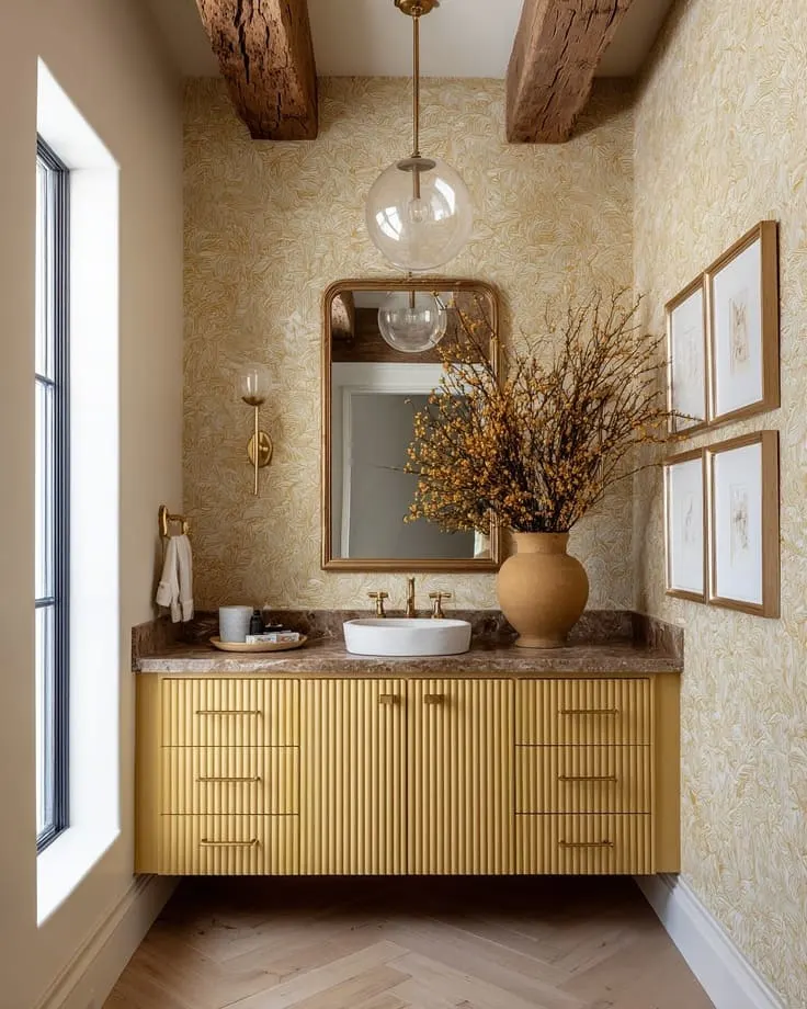 Yellow patterned bathroom wallpaper with a fluted vanity and brown marble countertop