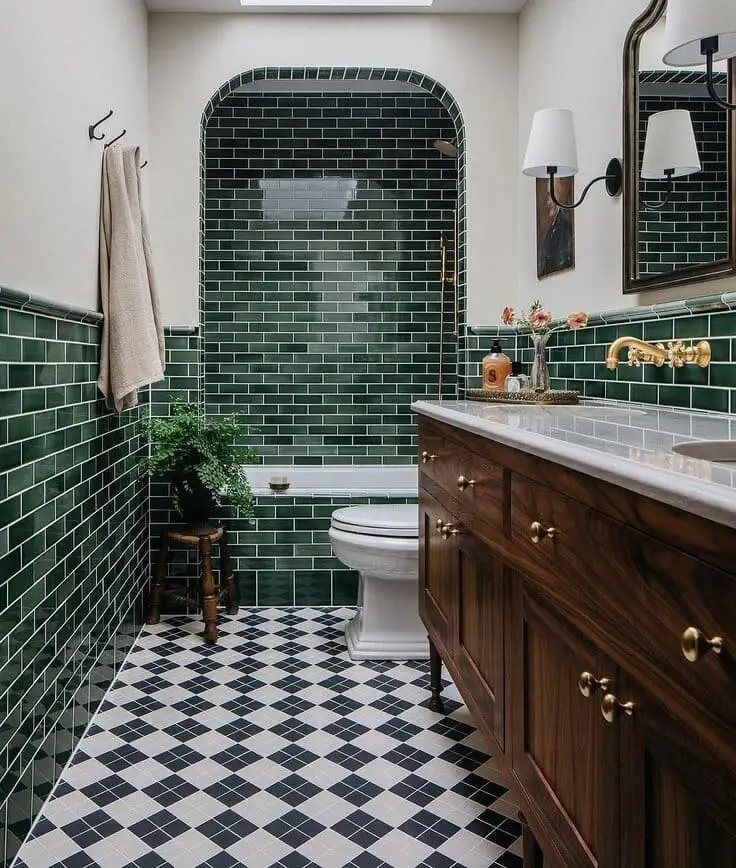 dark green tiled bathroom with wood vanity