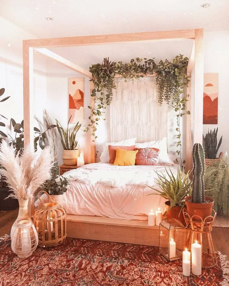 Cozy bohemian bedroom with greenery, pampas grass, and soft candlelight