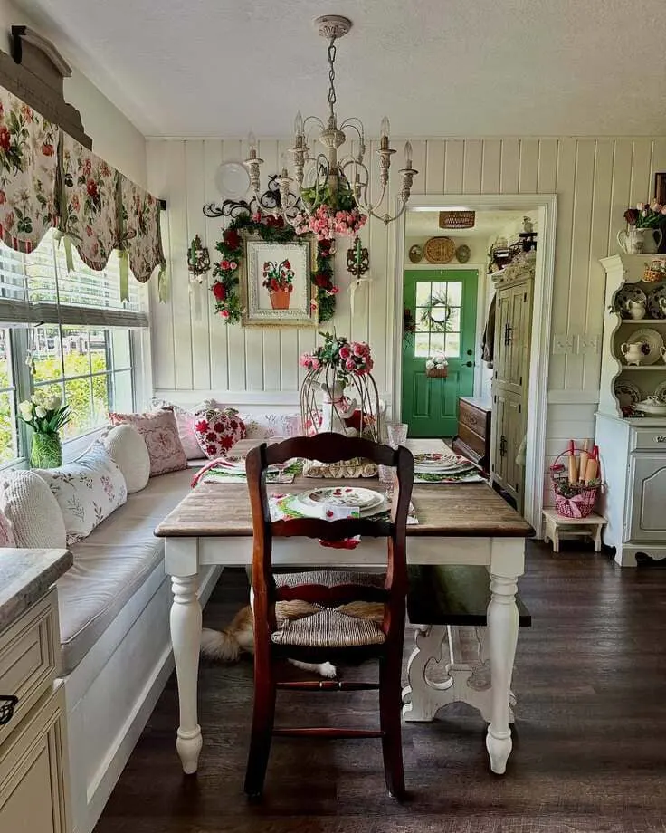 French country breakfast nook with floral decor and cozy bench seating