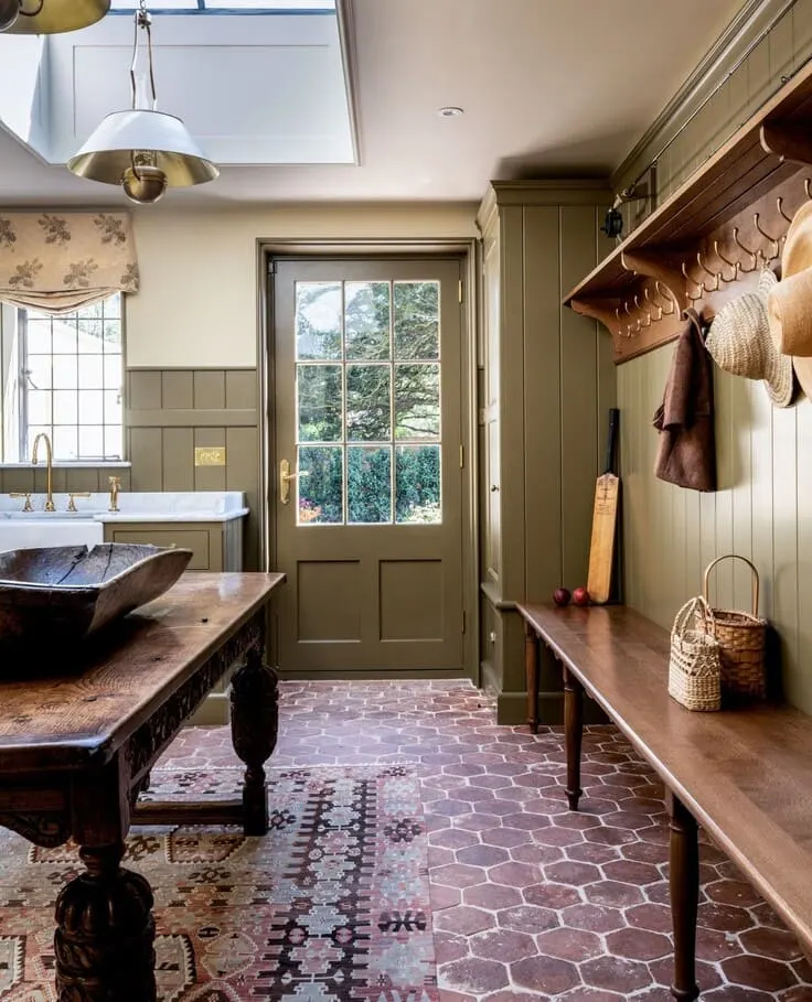 French country kitchen with olive green cabinetry and terracotta tile floors