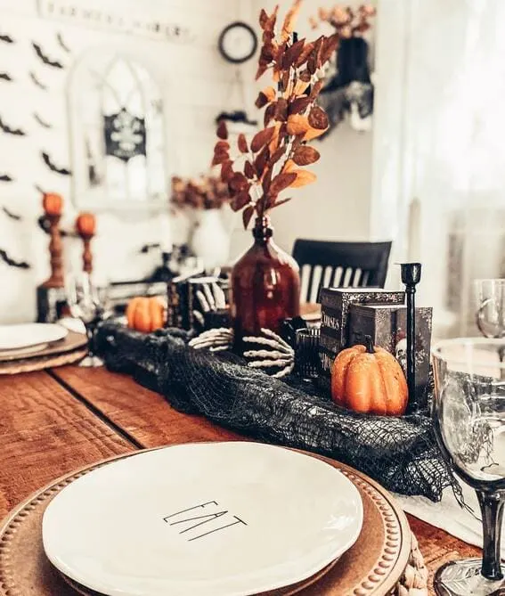 Warm and cozy dining table with rustic Halloween decor.