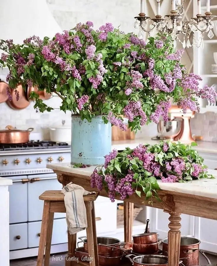 French country kitchen with lilac flowers and copper accents