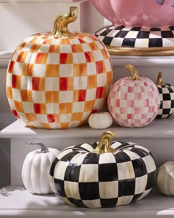 A vibrant collection of checkered pumpkins in various sizes and colors, bringing a whimsical twist to fall decor.